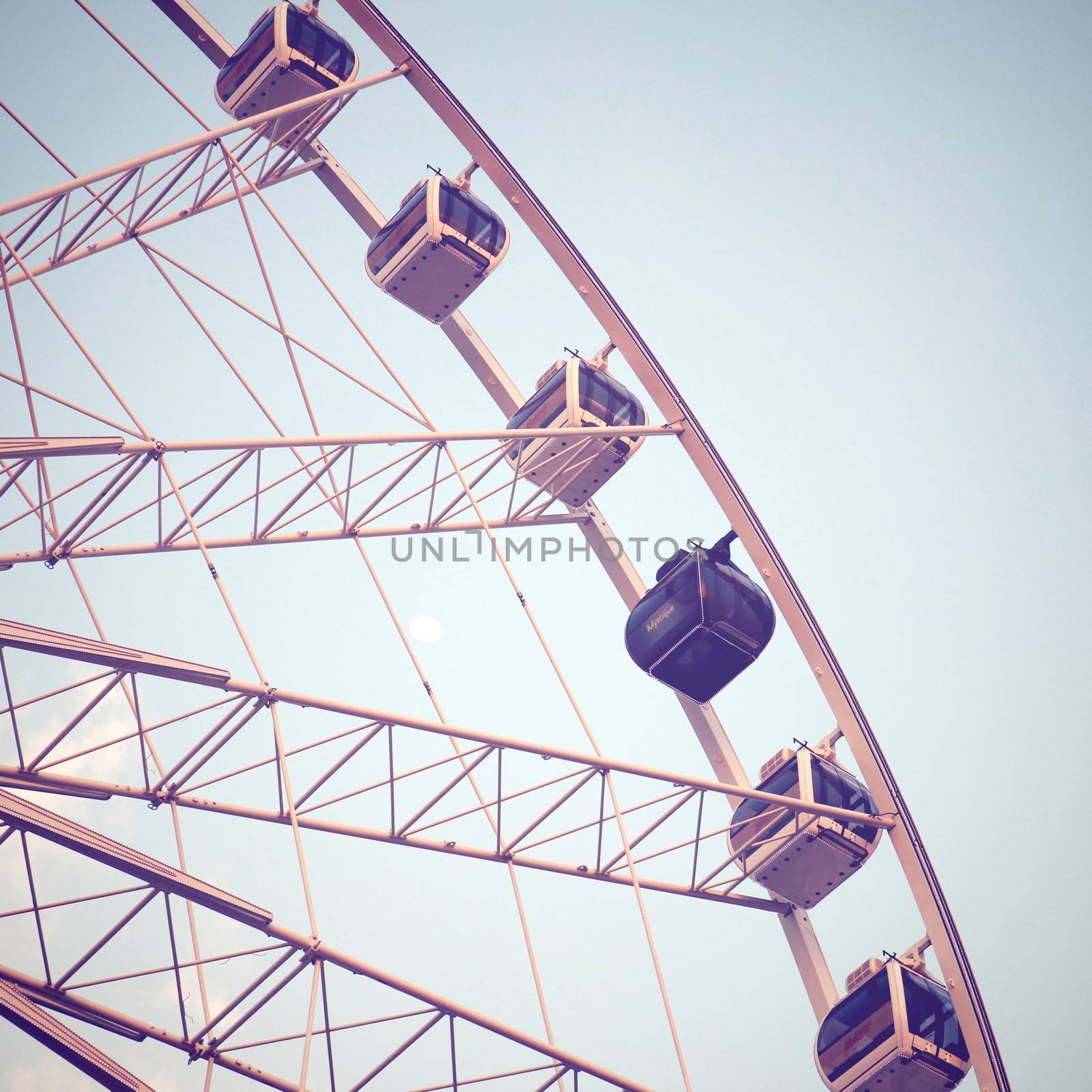 Ferris wheel and blue sky with retro filter effect  by nuchylee