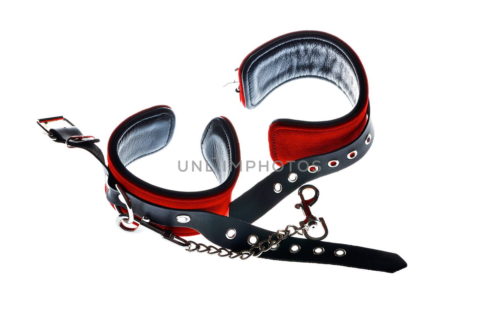 Red leather handcuffs in white background