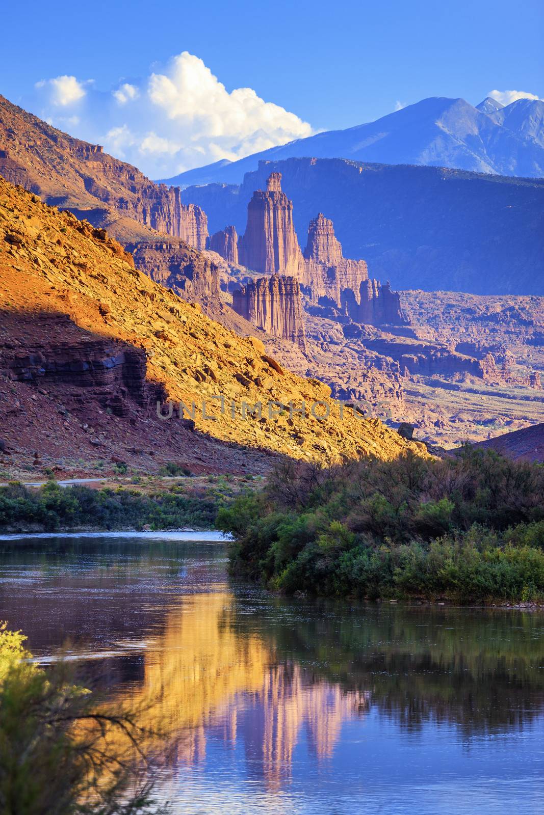 The Fisher Towers partially lit by the late afternoon sun reflected in the Colorado River near Moab,Utah 