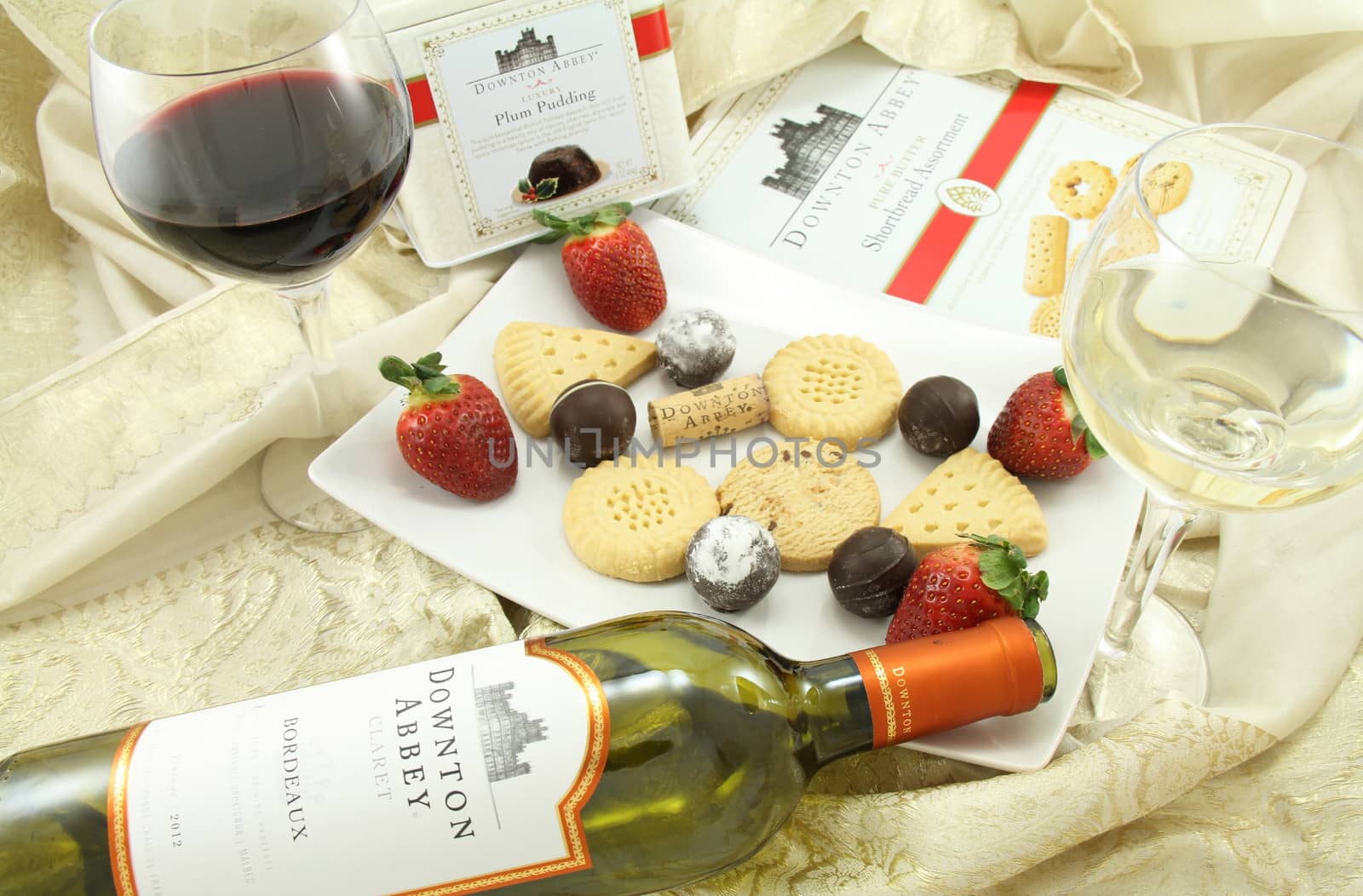 FRISCO, TX USA - February 13, 2014: Downton Abbey wine, shortbread and plum pudding with strawberries and chocolates. The show is an international hit series about an English manner in the early 1900's seen on  PBS Masterpiece.