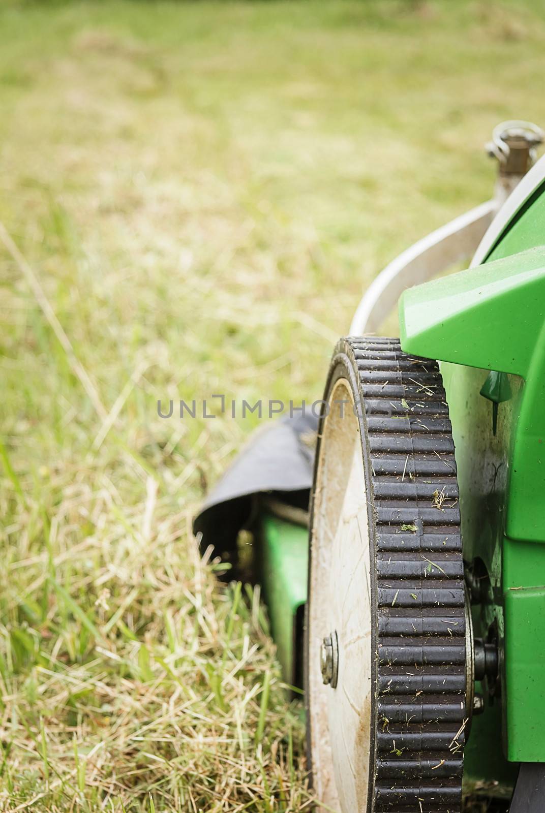 Closeup of lawnmower in the garden ready to cut lawn
