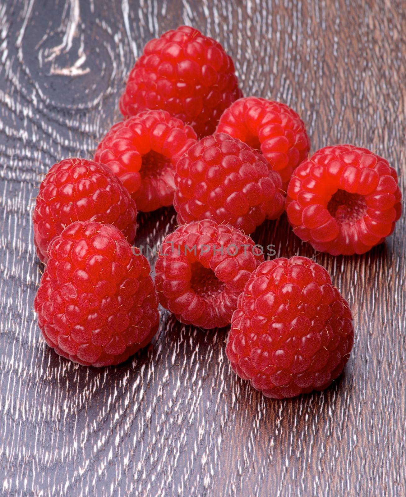 Heap of Fresh Ripe Raspberries isolated on Hardwood background