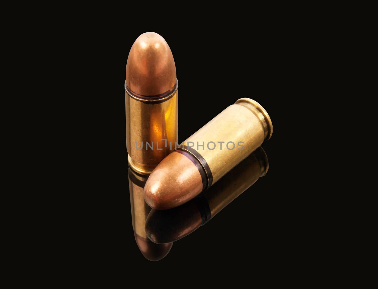 two bullets with reflection on black background