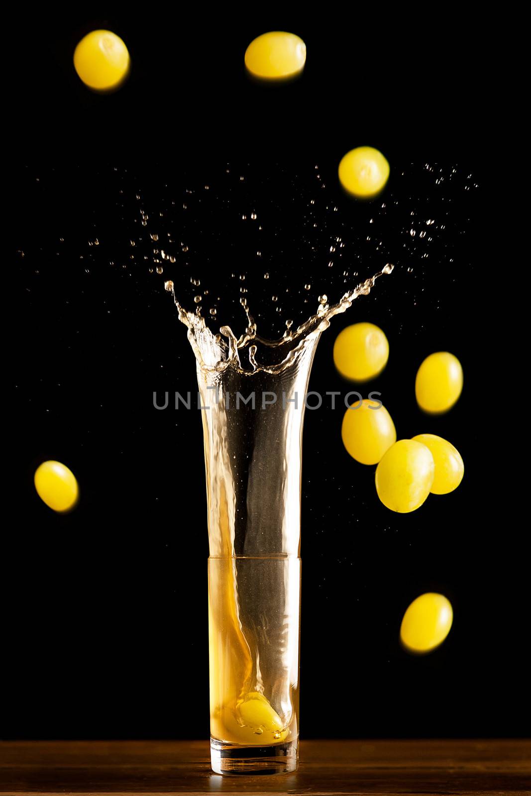 Grapes falling into a glass of fine wine