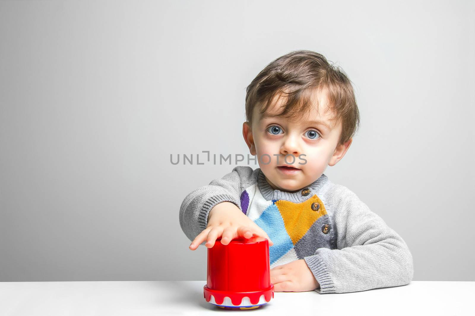 Child playing with his didactic toys