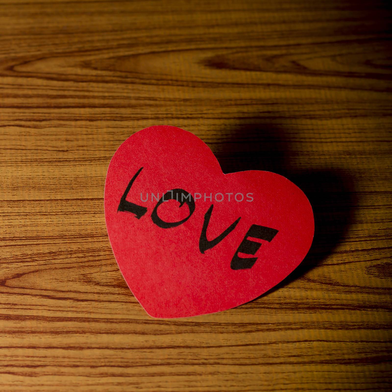 red heart word LOVE on wood vintage stlye background