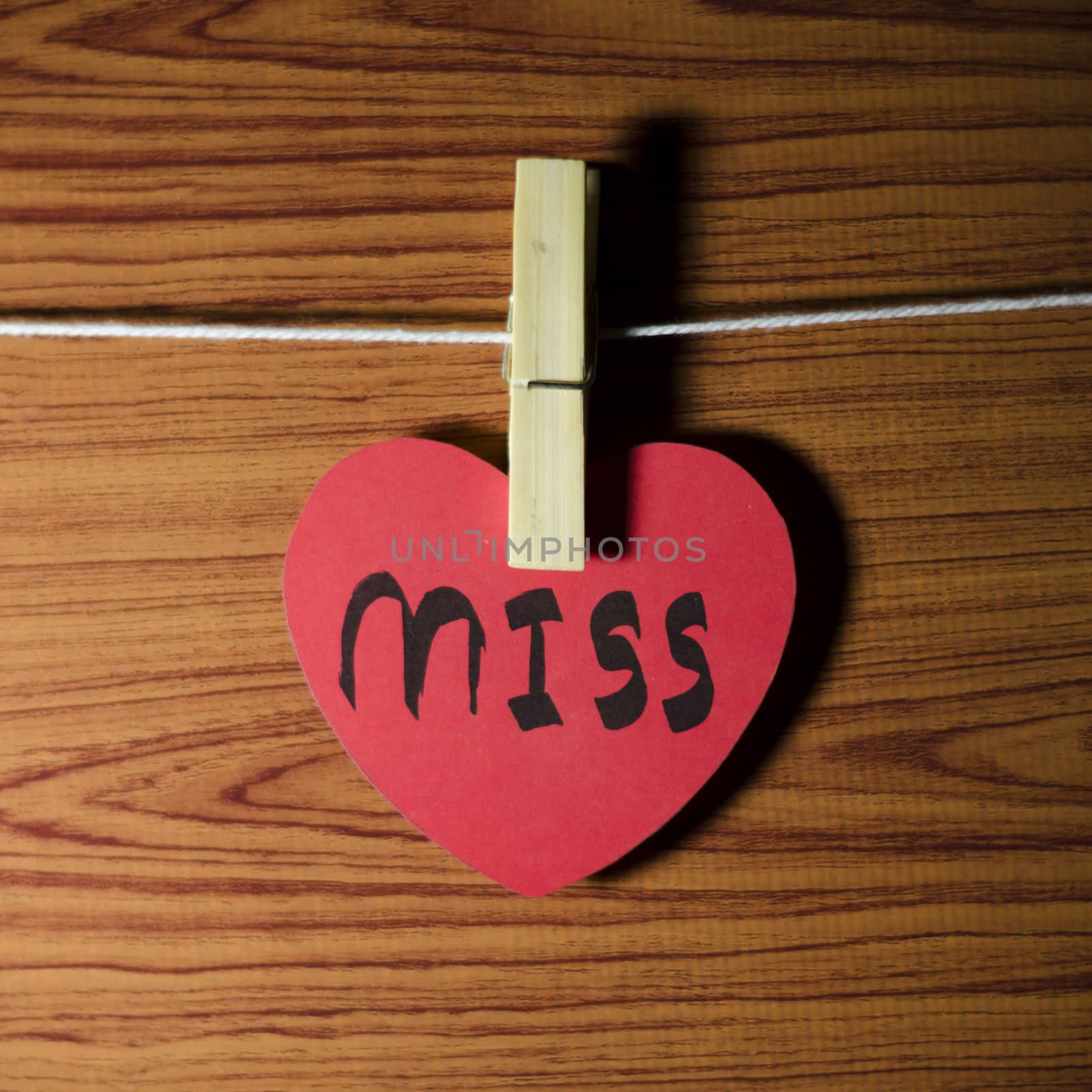 red heart word miss on wood vintage stlye background