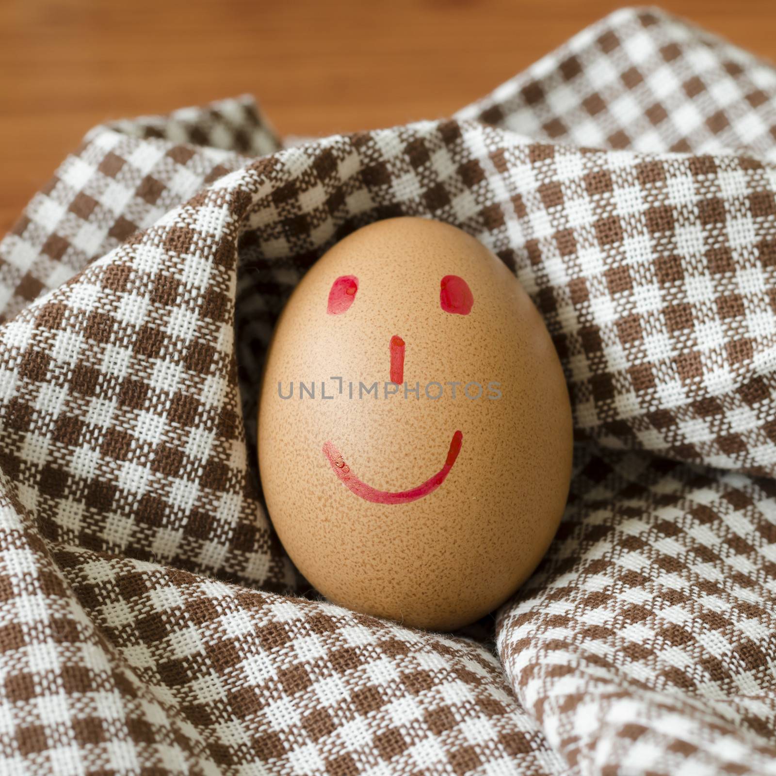 smile love egg couple in brown kitchen towel on wood table