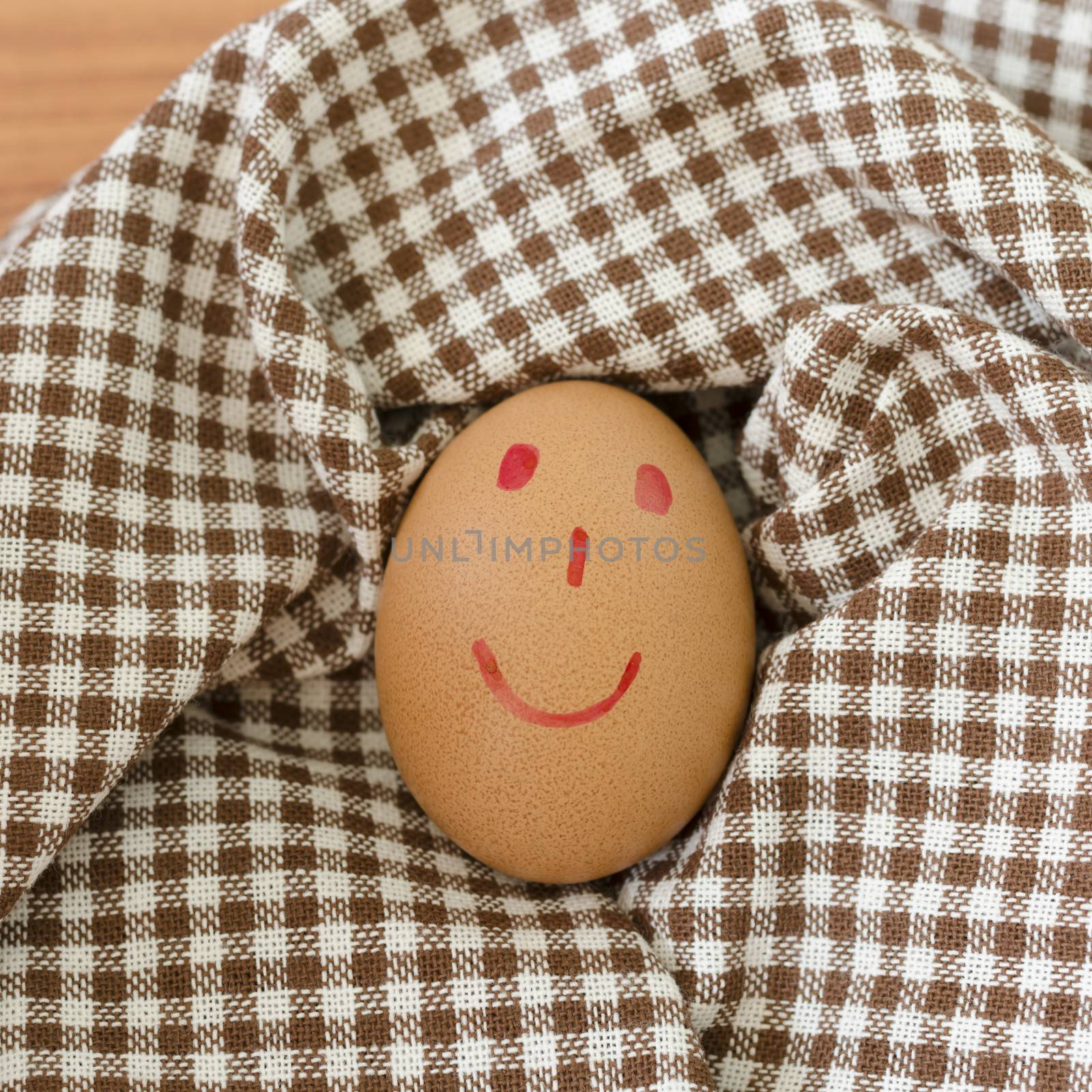 smile love egg couple in brown kitchen towel on wood table