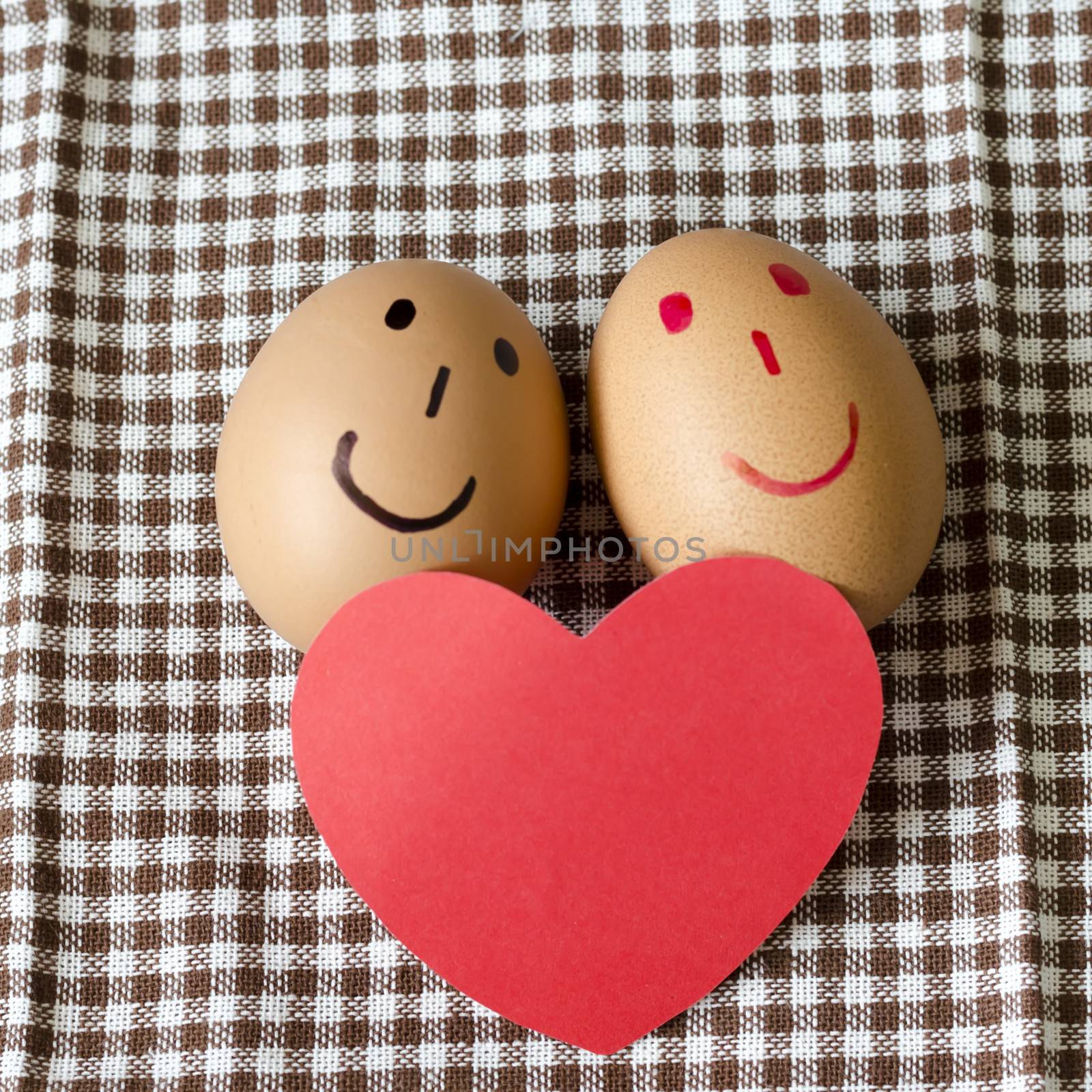 smile love egg couple in brown kitchen towel on wood table