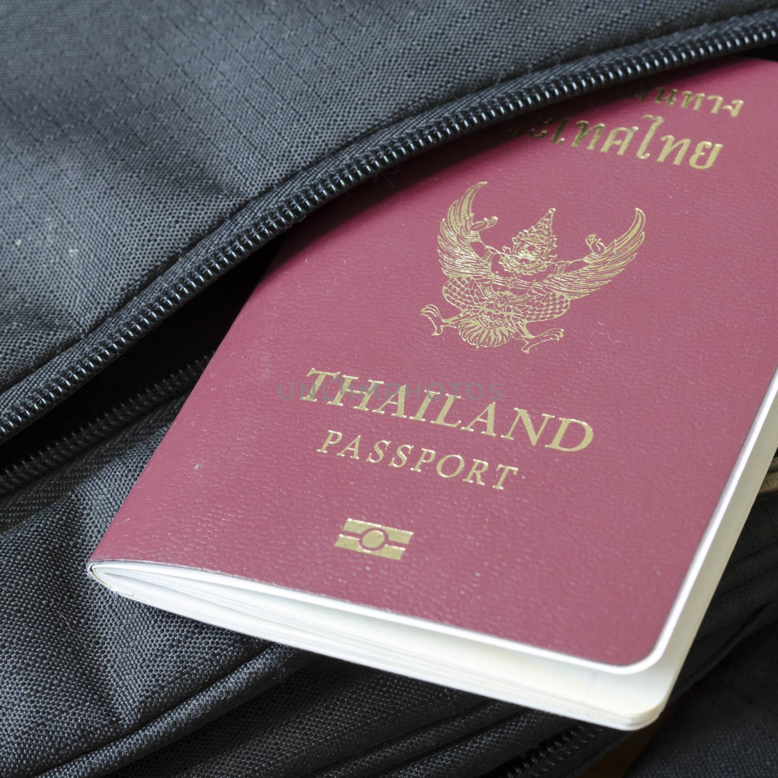 thai passport in black bag