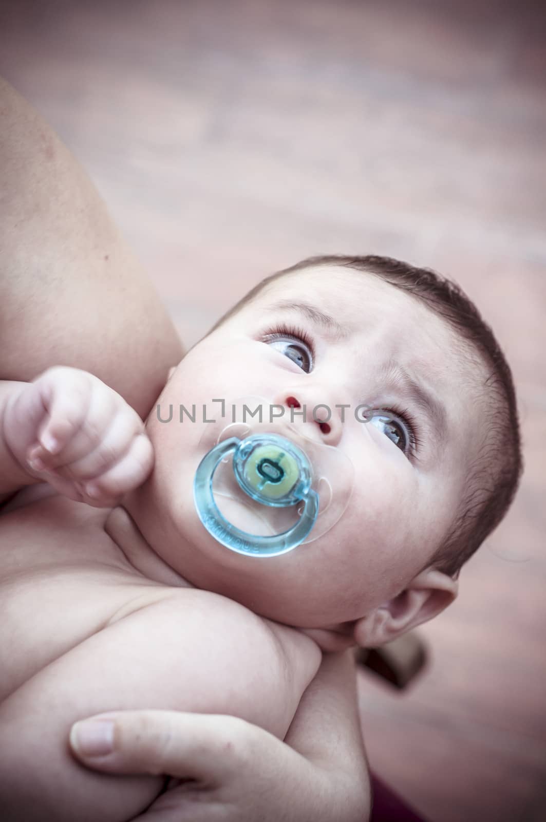 new born baby curled up sleeping on a blanket, multiple expressions