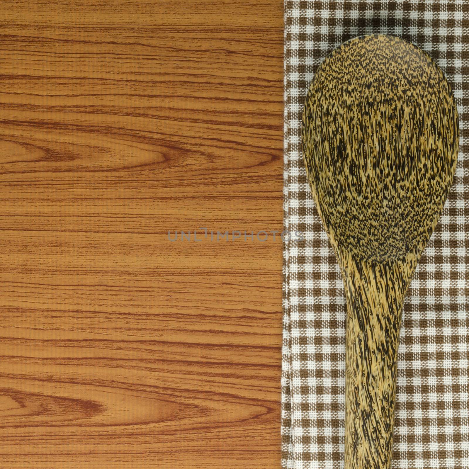 kitchen towel with spoon on wood background by ammza12