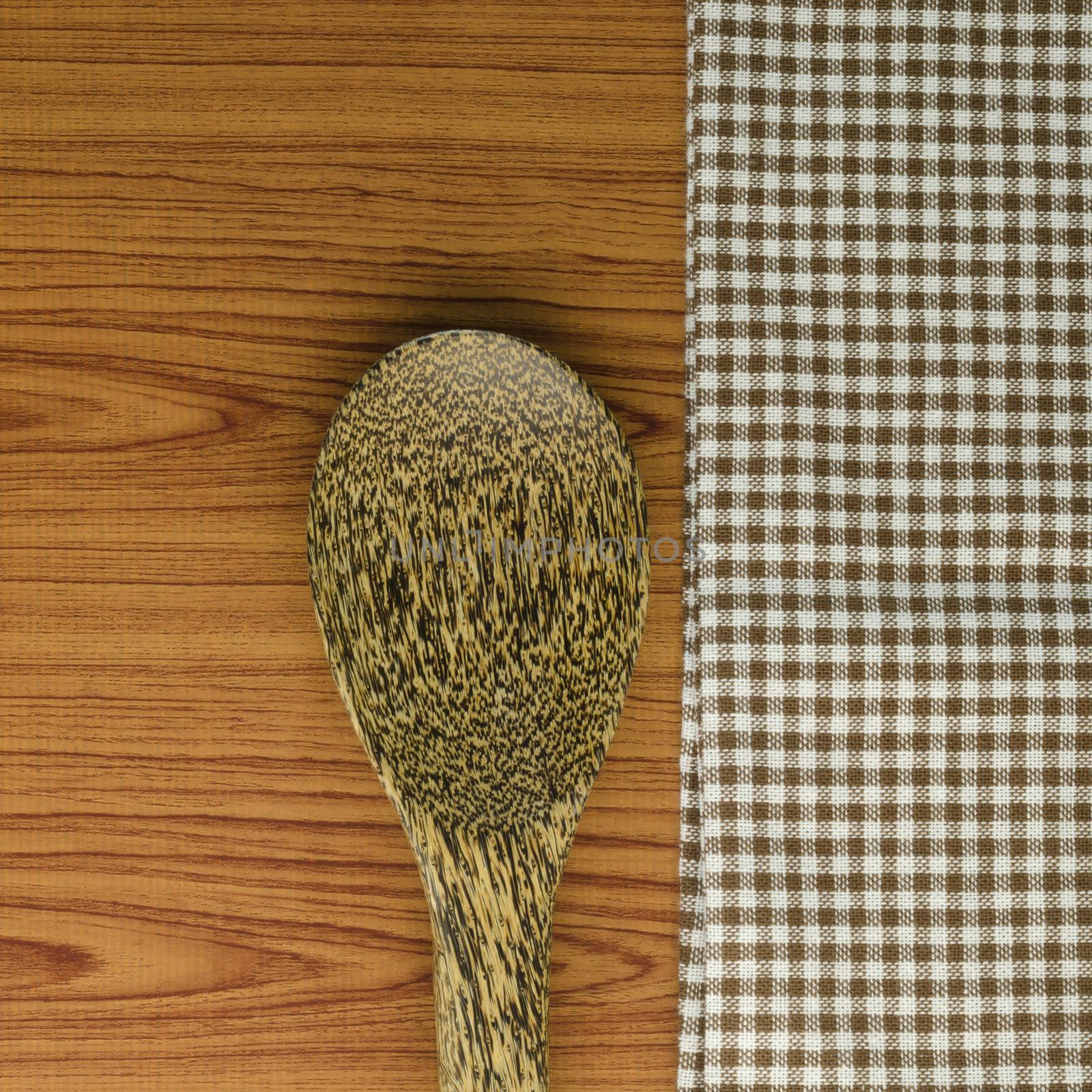 kitchen towel with spoon on wood background by ammza12