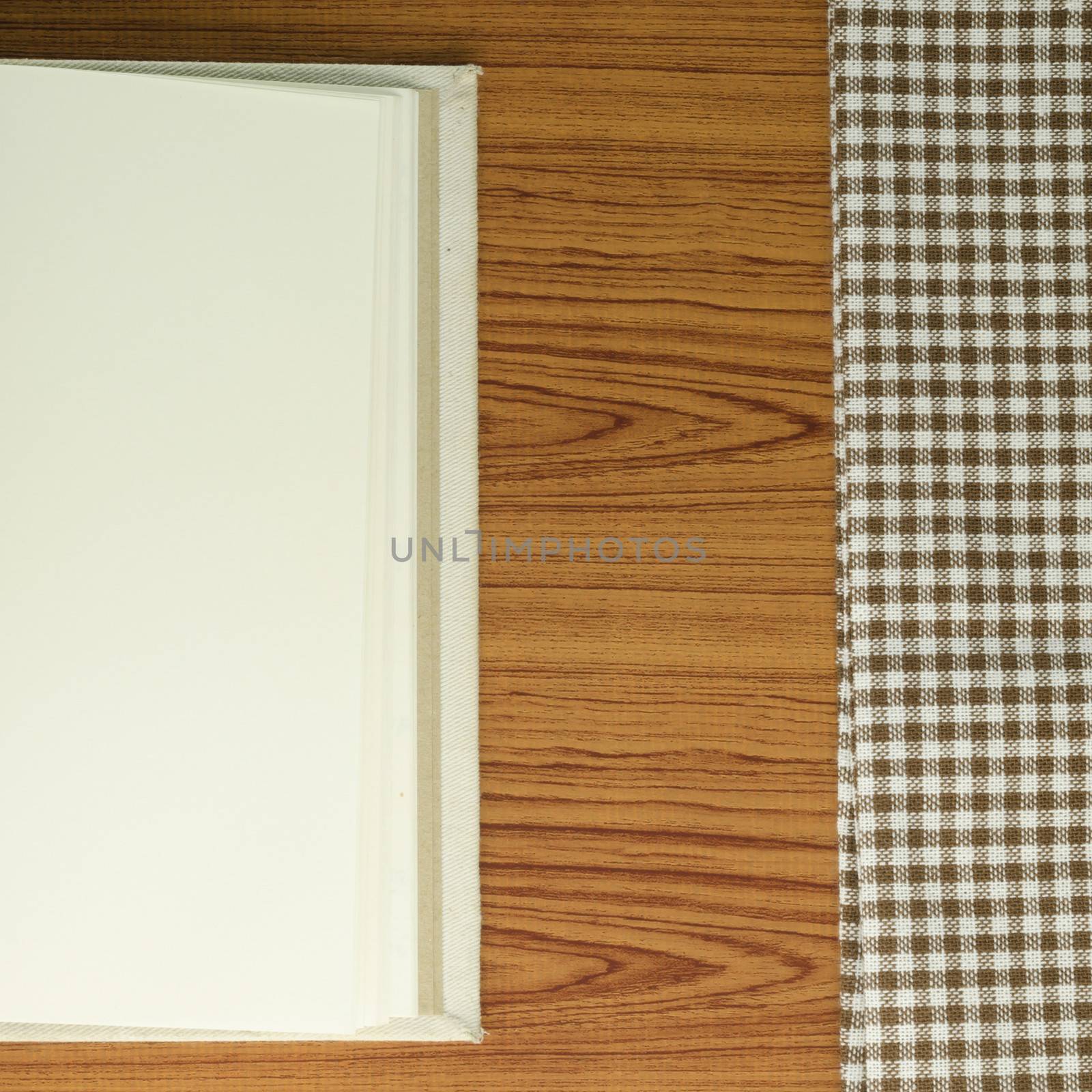 notebook with kitchen towel on wood background