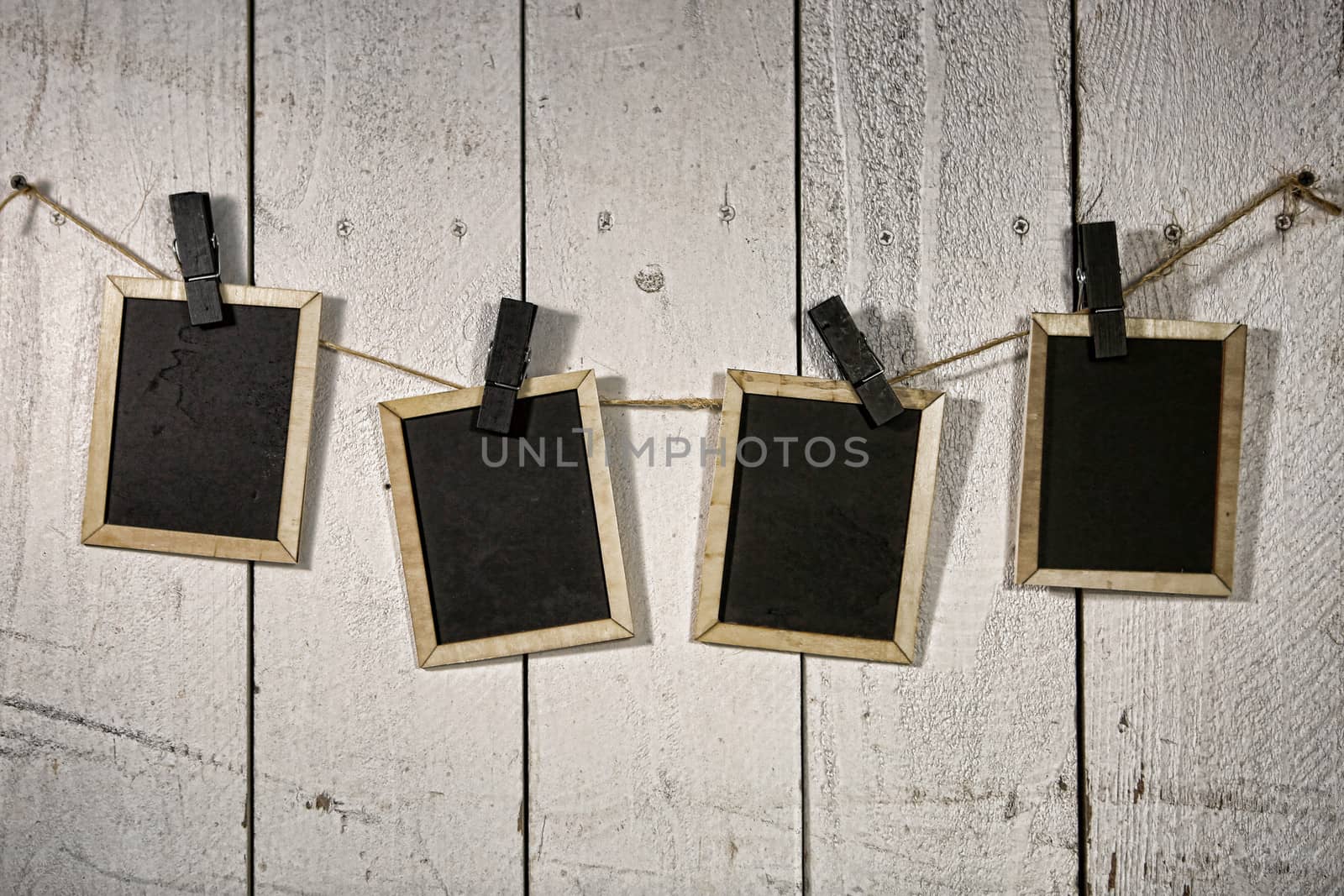 Film Looking Chalkboards Hanging on a Rope Held By Clothespins by tobkatrina