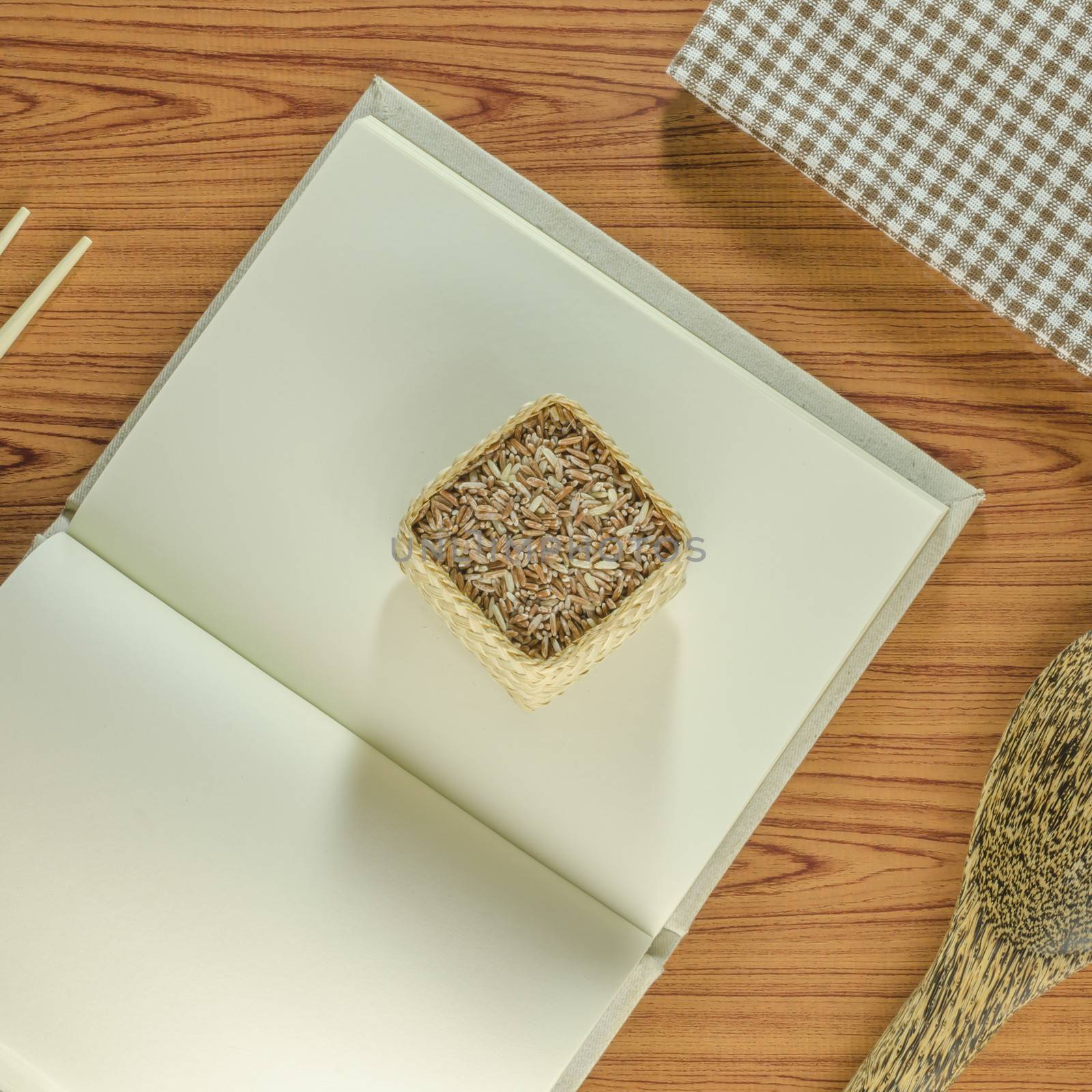 brown kitchen towel with spoon on wood background