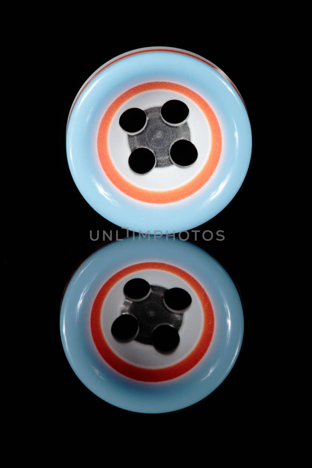 a colored button isolated in black