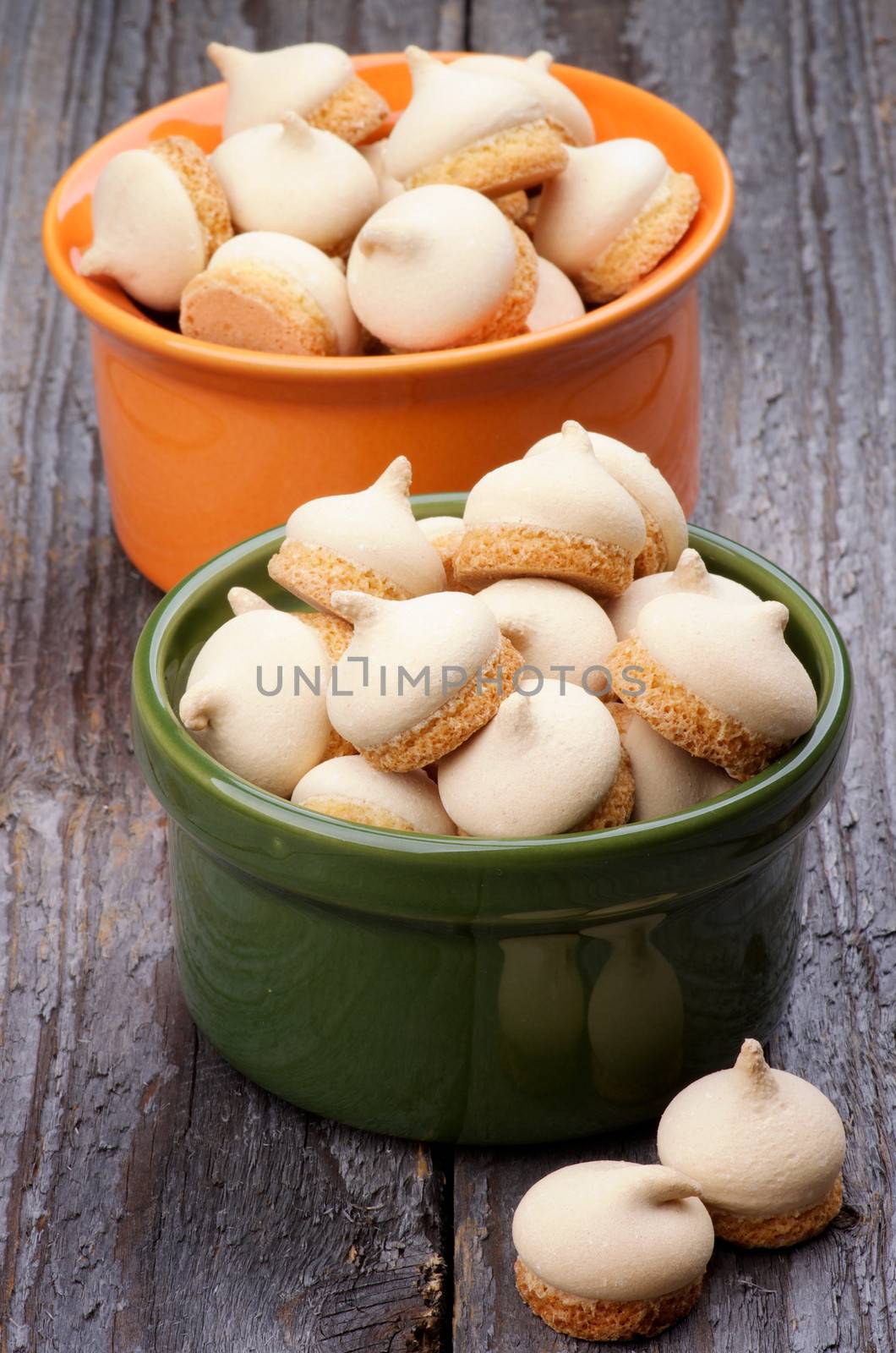 Arrangement of Swirled Meringue Topping in Two Bowls isolated on Rustic Wooden background