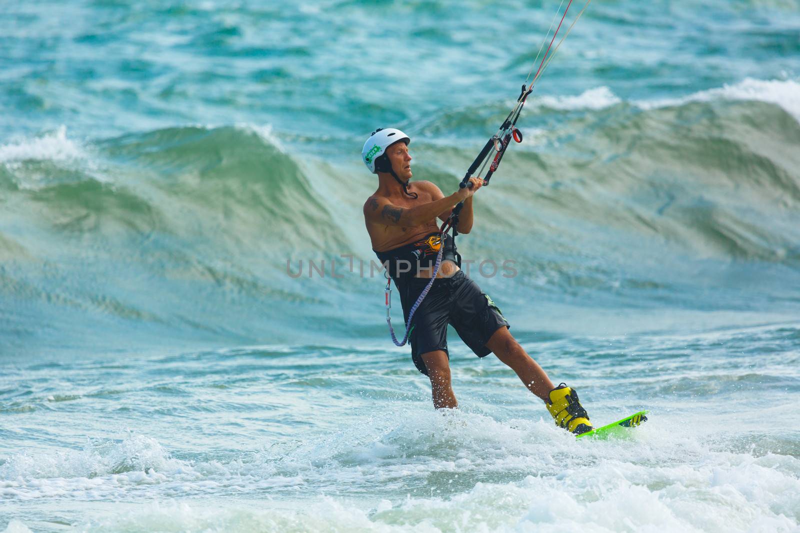 MUI NE, VIETNAM - JANUARY 30, 2014: Unidentified kitesurfer at Mui Ne resort beach on January 30, 2014 in Mui Ne resort, Vietnam.