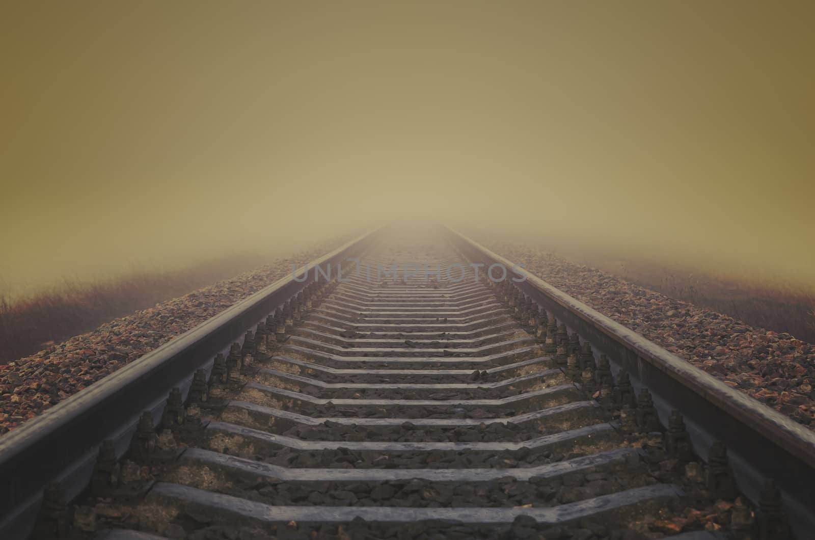 grunge railroad to horizon in fog