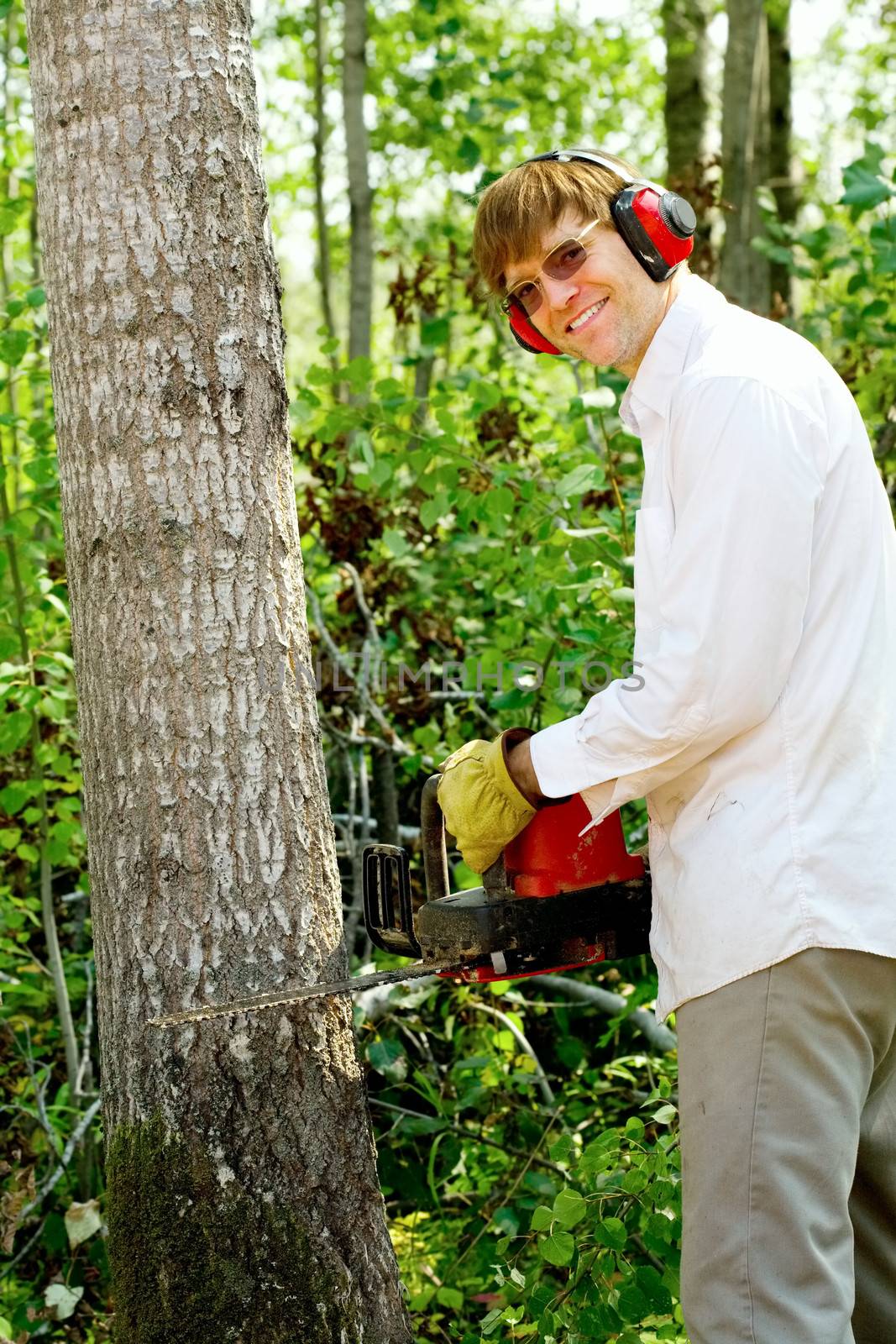 Man cutting down a tree by jarenwicklund