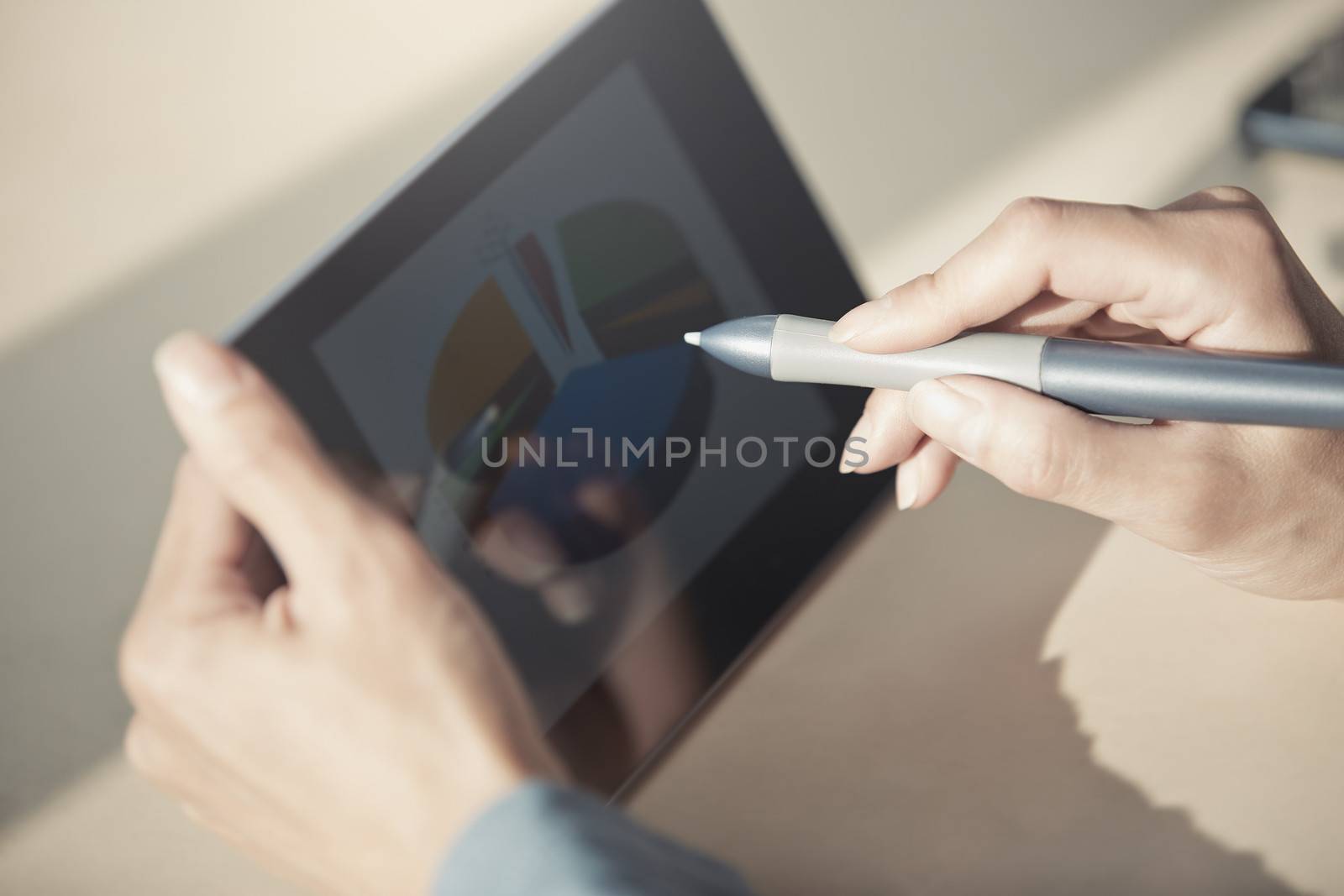 Human hands using tablet PC and sylus for diagram working. Diagram was created by me