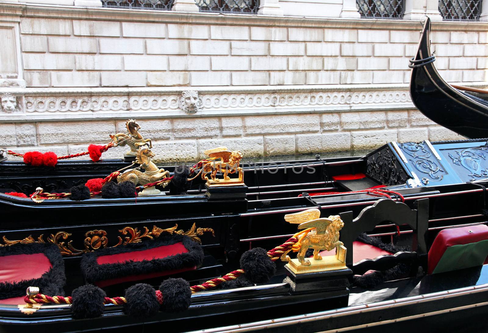 Italy. Venice. Details of typical venitian gondolas. The winged lion and golden horse on a venetian gondola.