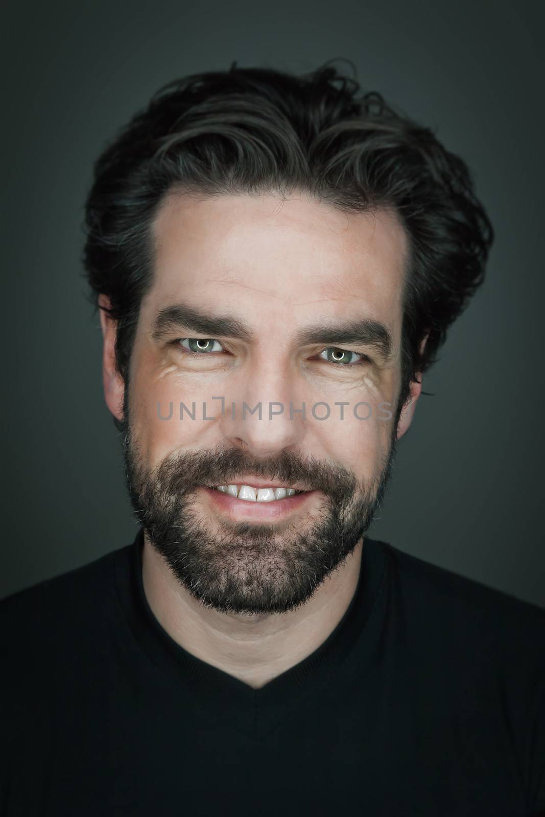 An image of a handsome smiling man with a beard