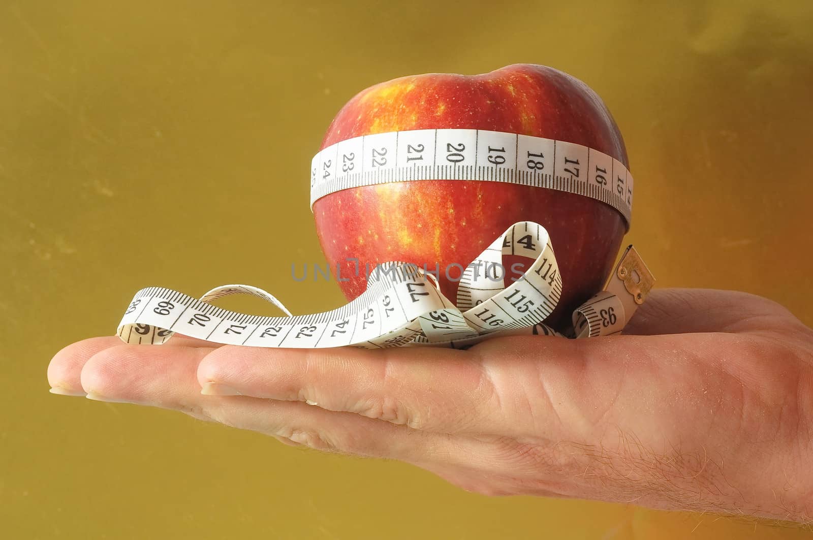 Diet Apple and Meter on the Hand a Colored Background