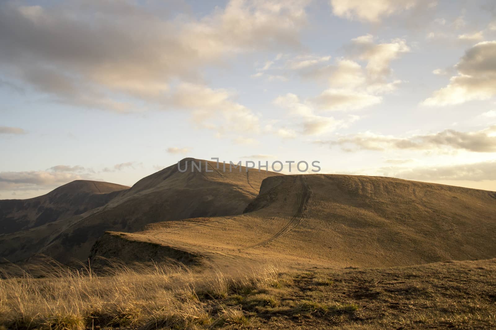 Mountain peaks in the autumn evening sky with clouds