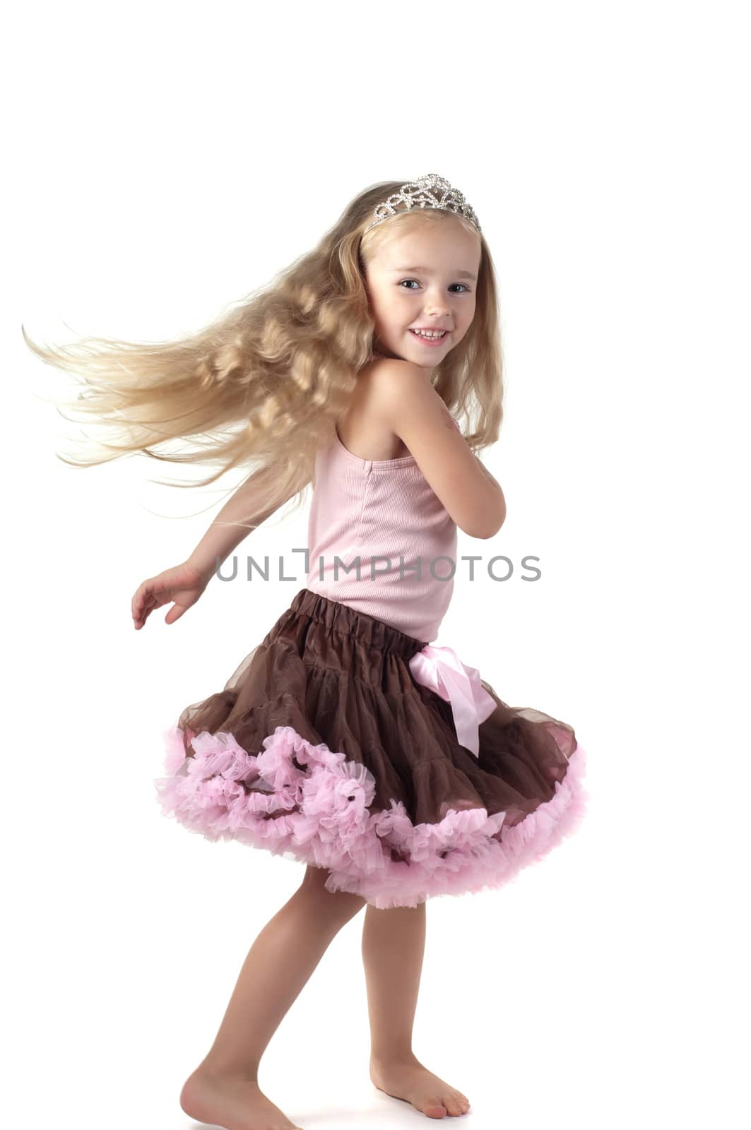 Shot of dancing little girl with long blond hair in studio