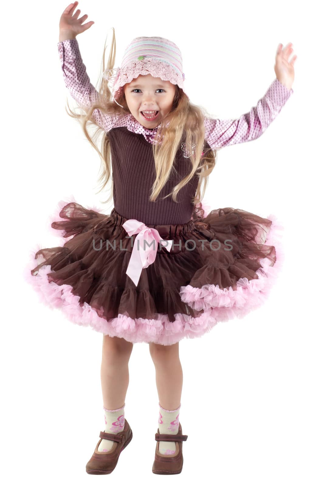 Shot of jumping little girl with long blond hair in studio