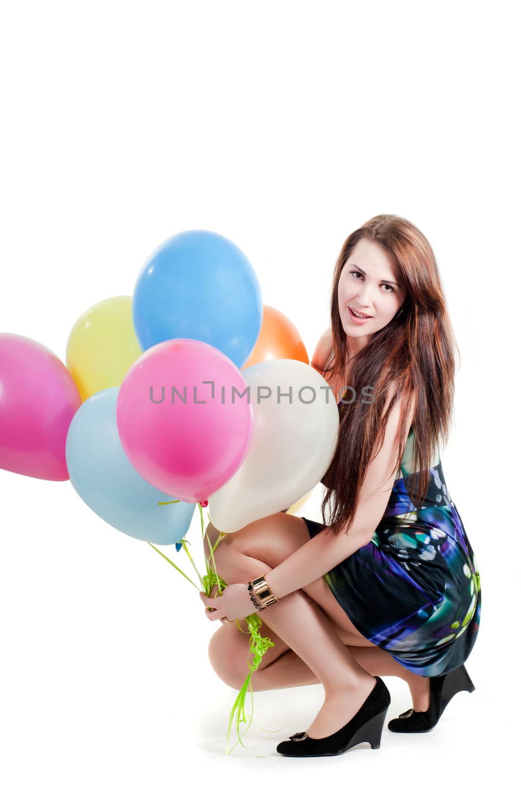 Shot of beautiful female keeping in hand multicolored air balloons