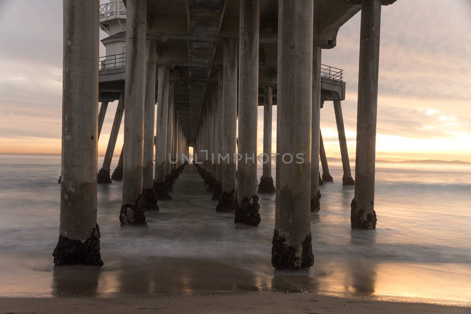 Long exposure captures slow moving waves under The Huntington Beah Pier in Huntington Beach, California