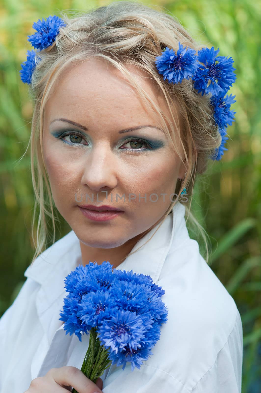 Portrait of beautiful female in white shirt with blue flowers