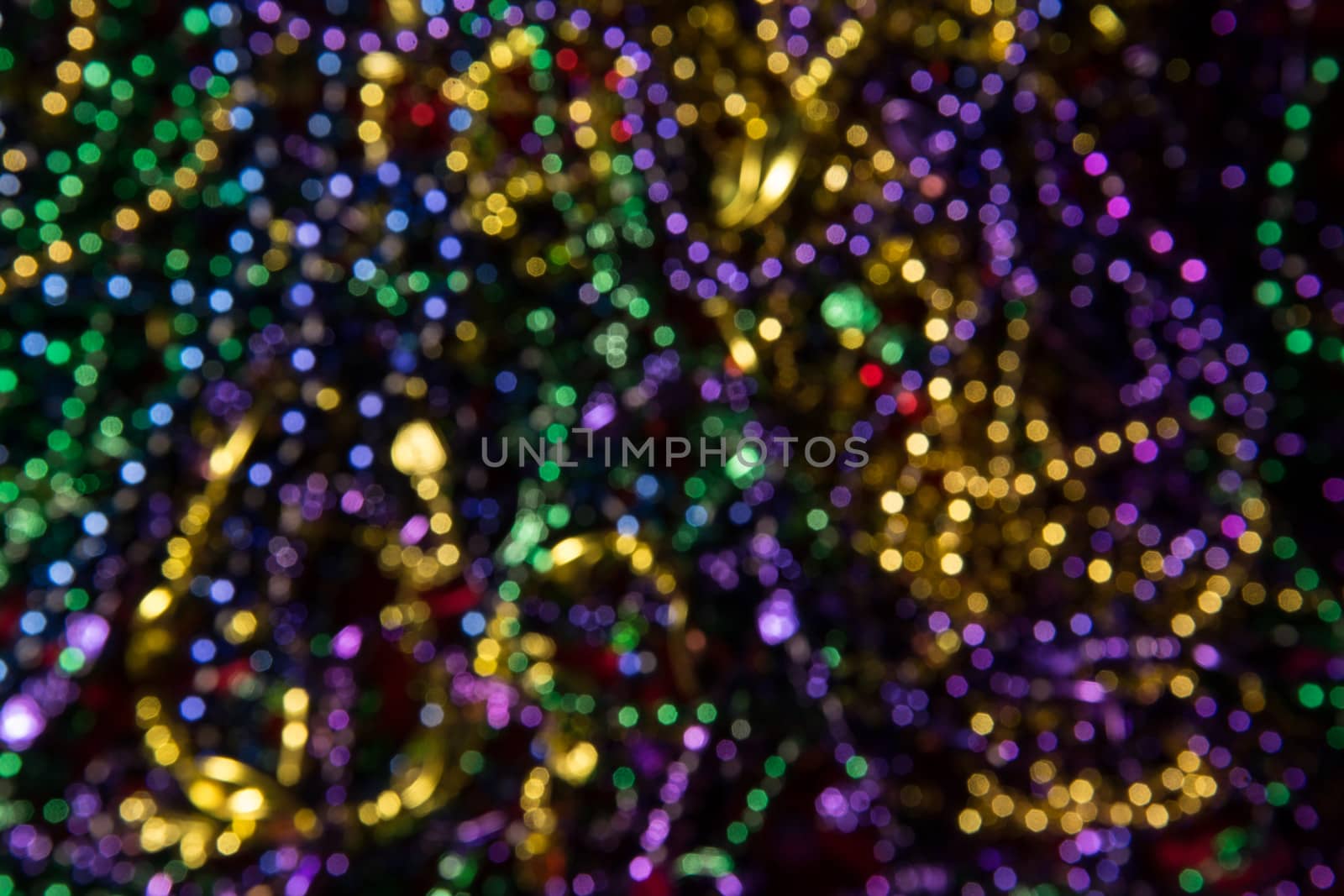 Abstract background of out of focus Mardi Gras Beads