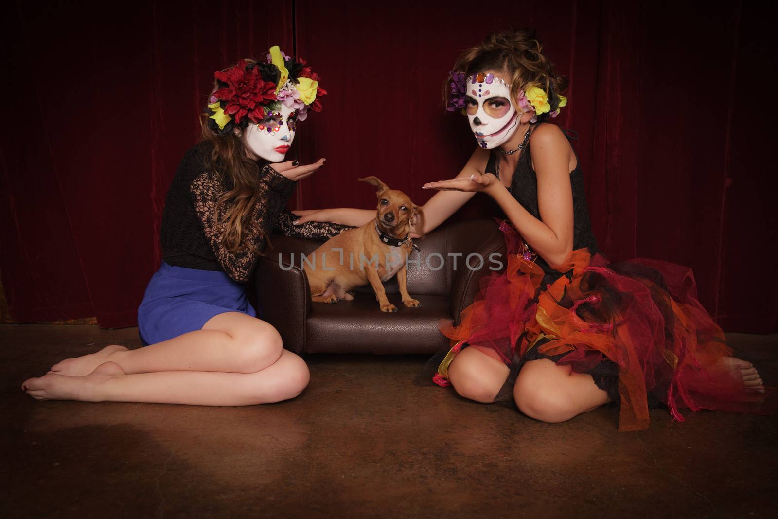 Day of The Dead girls in costume and make up blowing kisses to Chiweenie dog