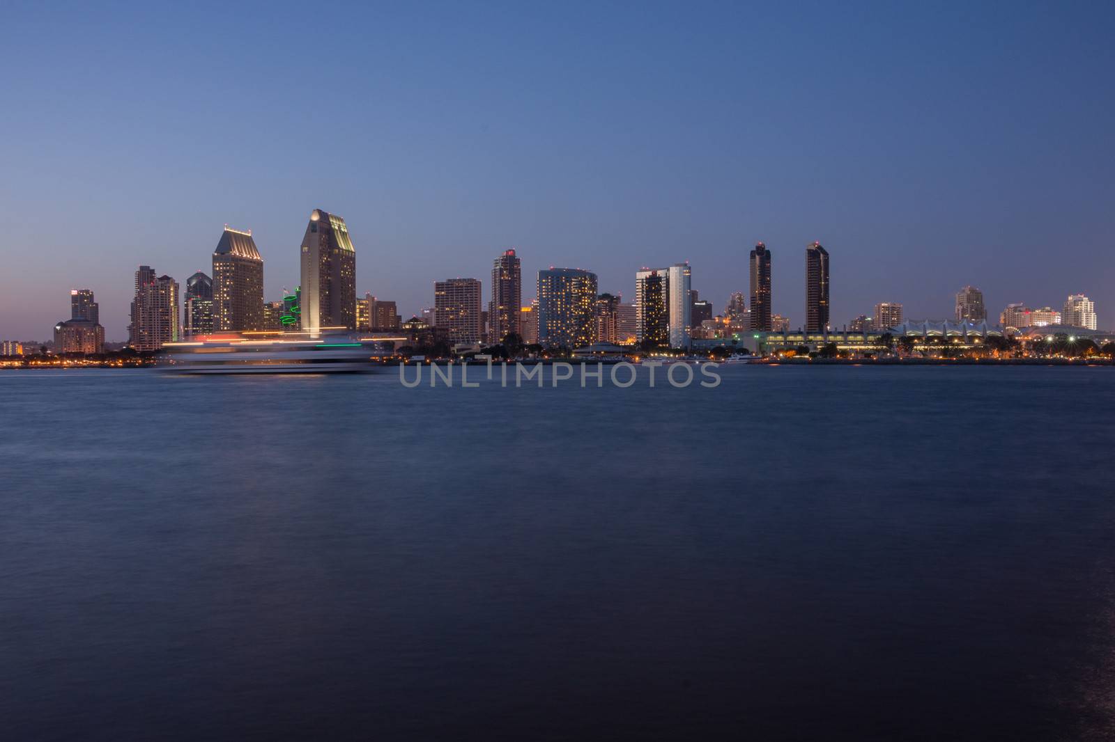 Scenic San Diego Bay and tall buildings downtown. Harbor boats with motion blur