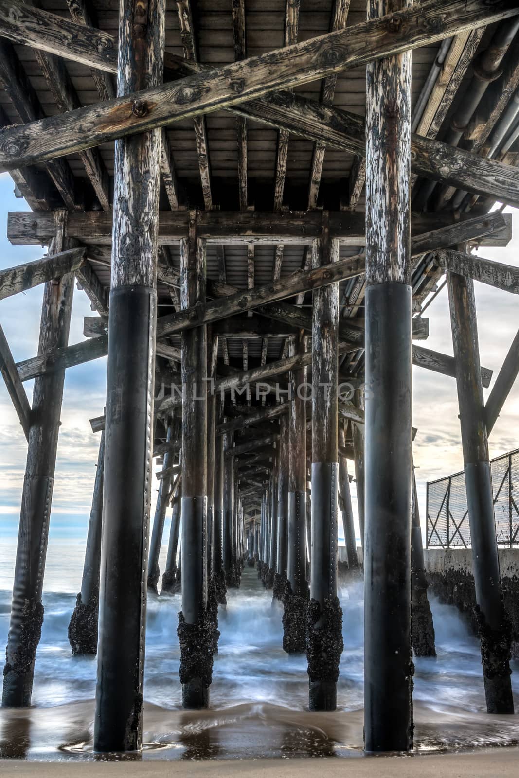 Long exposure captures slow moving waves under The Seal Beach Pier in beautiful Seal  Beach, California