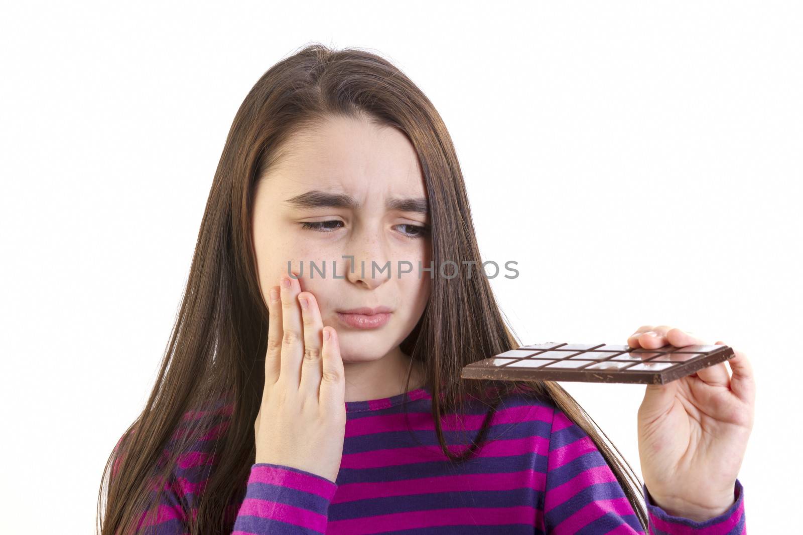 Girl child with toothache because his eats chocolate