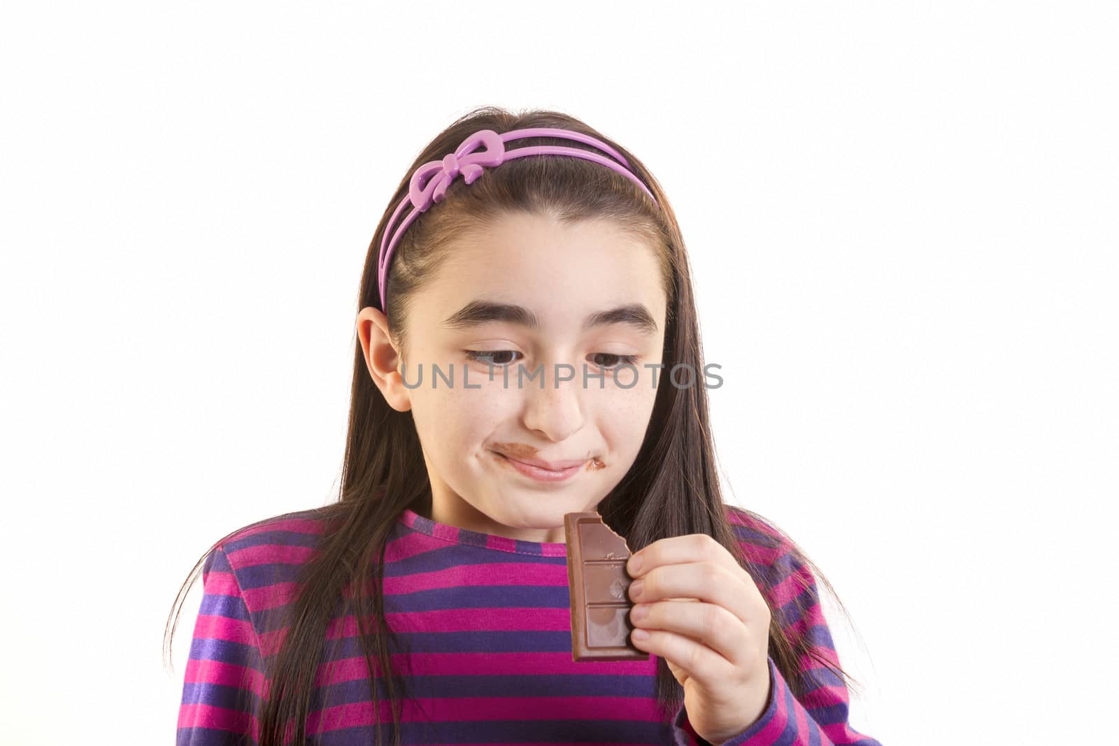 Young girl eating chocolate by manaemedia