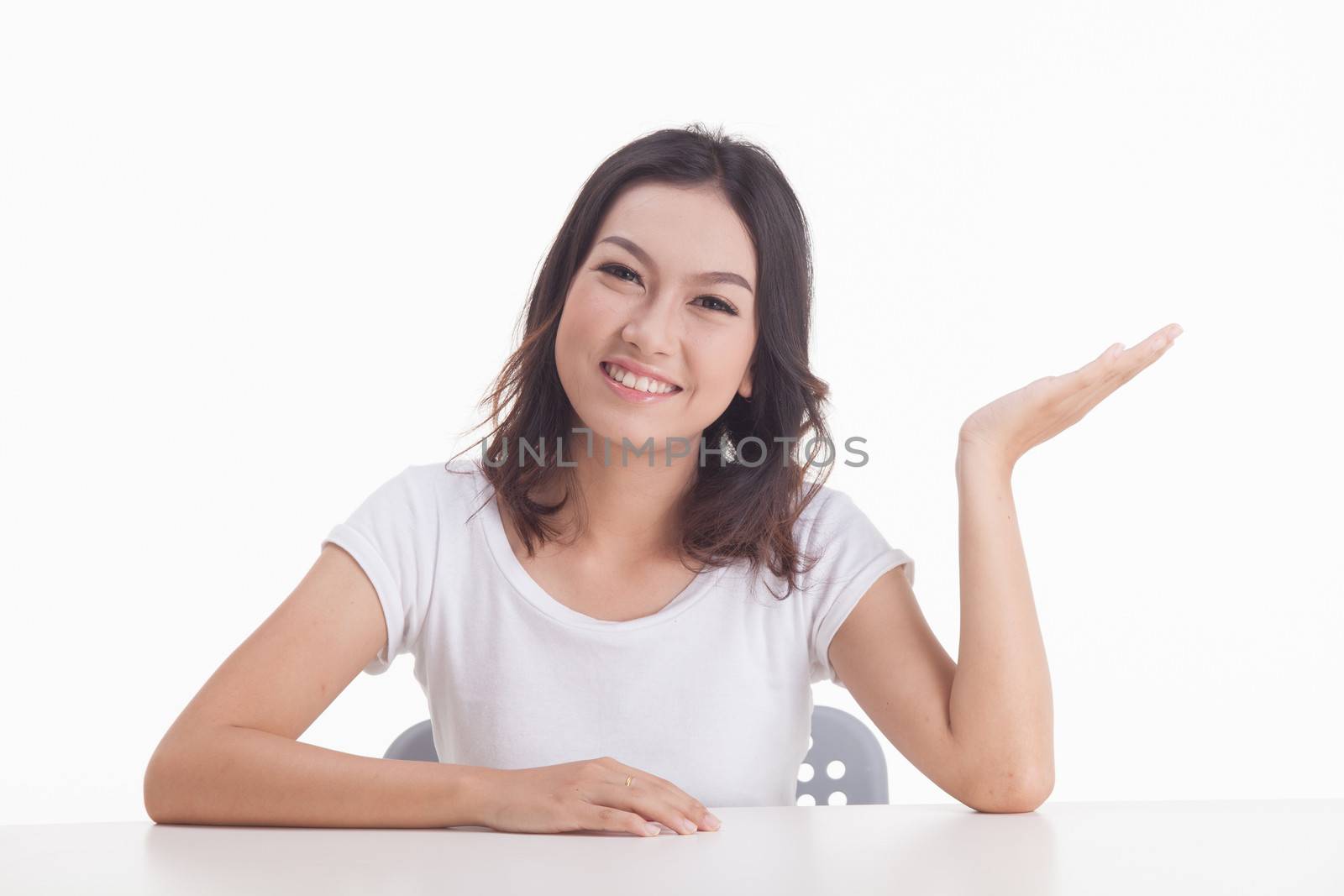 Asian woman isolated on white background. white t-shirt, sit on chair with table