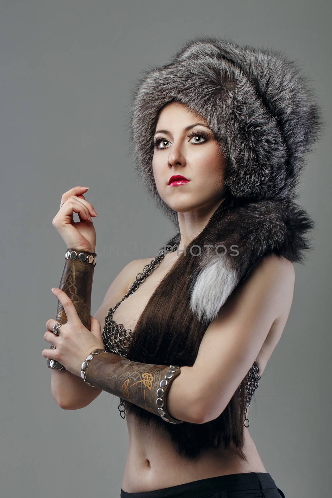 Attractive young girl warrior in chain mail and fur hat
