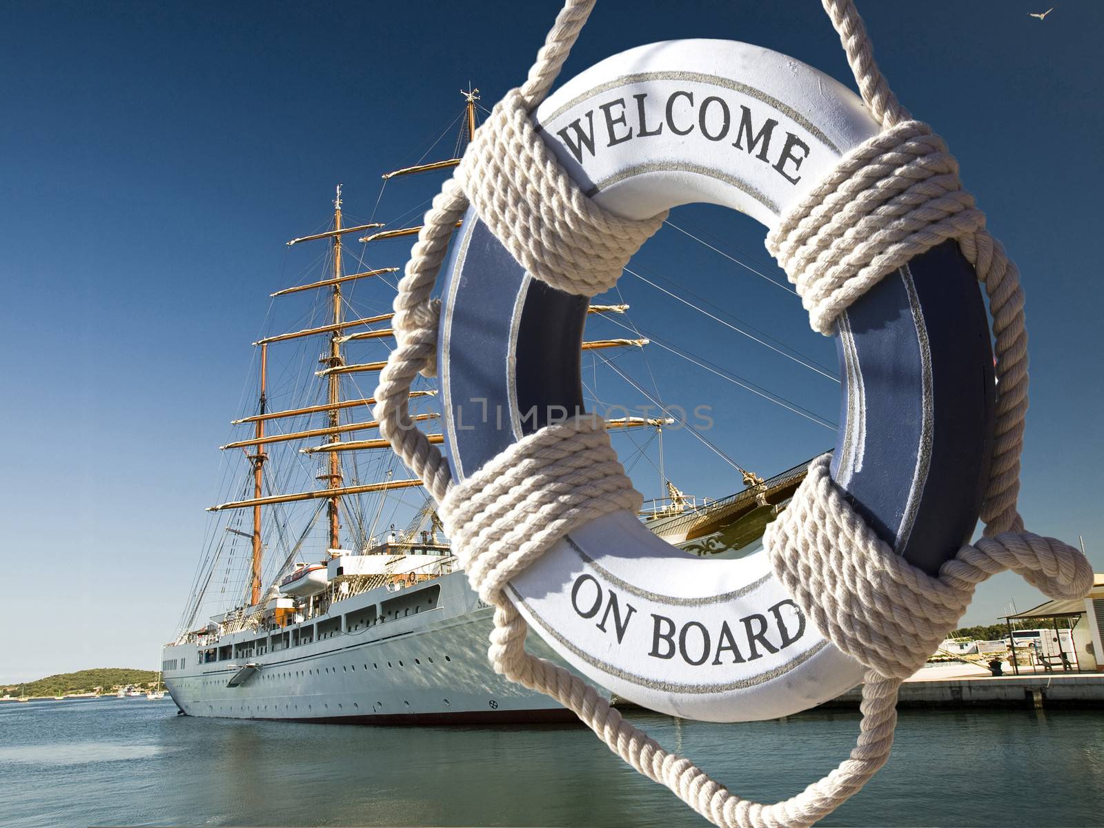 wiew on the sailing ship thru blue safe belt with welcome on board sign