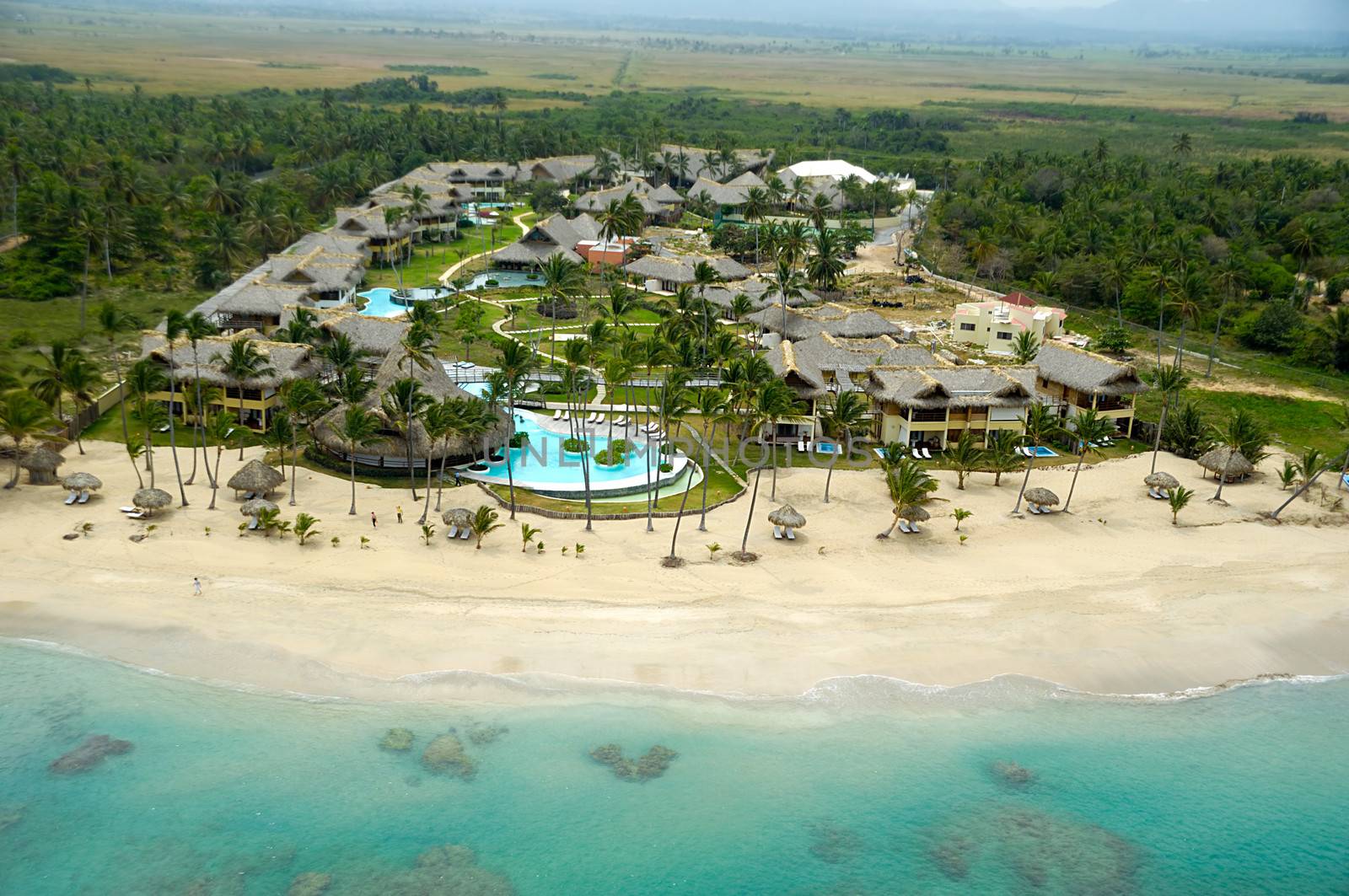 Hotel resort near exotic beach with palms. The Dominican Republic.