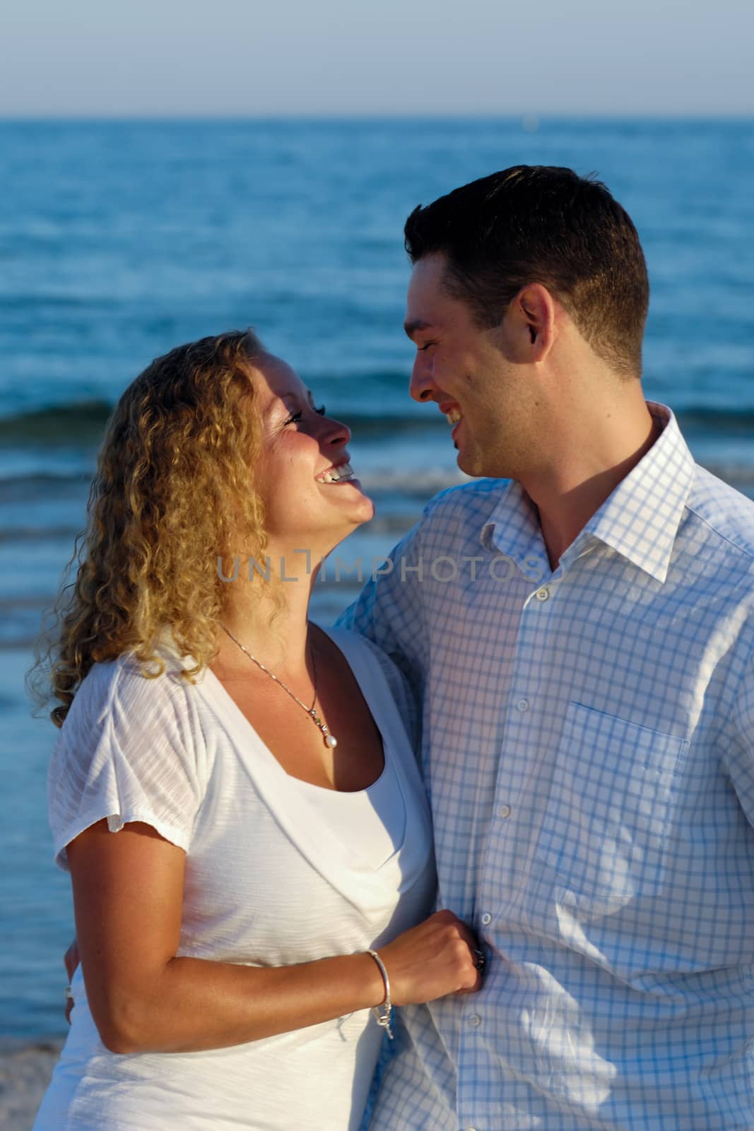 A happy woman and man in love at beach.