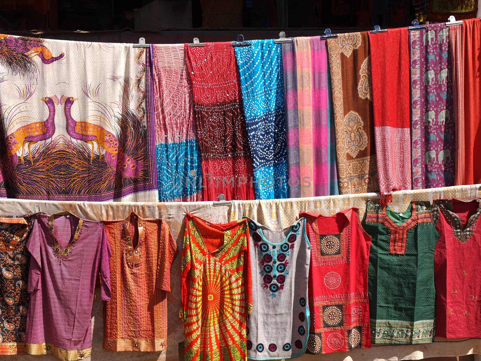 colorful dresses  scarfs and shirts on the open market in India      