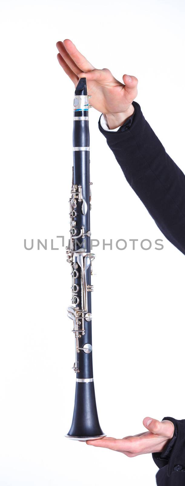 Clarinet in hands young man. Isolated on background.