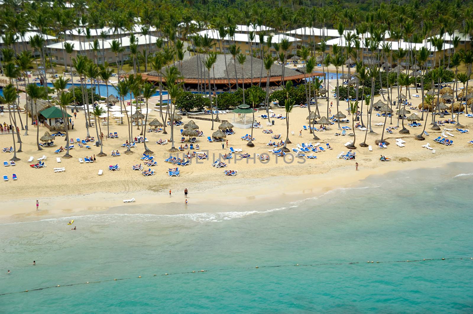 Hotel resort near exotic beach with palms. The Dominican Republic.